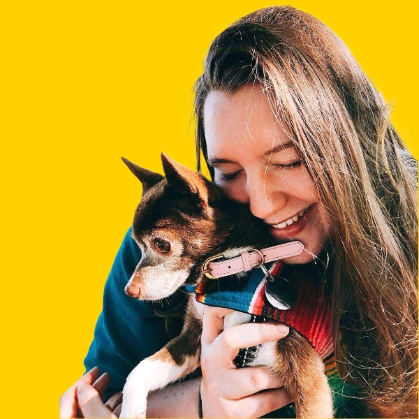 Woman holding a dog.